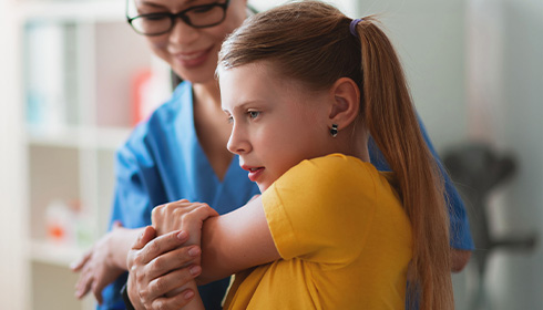 Girl getting physical exam with nurse