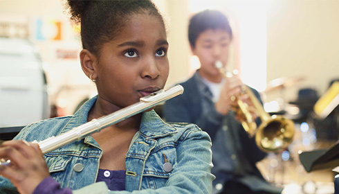 Female band student practicing the flute