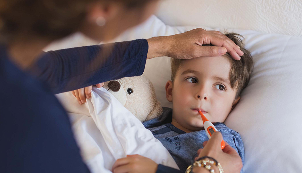 Mother checking temperature of sick boy